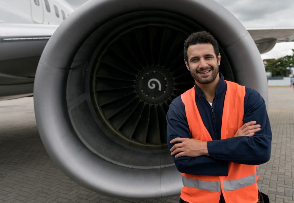 A aircraft maintenance engineer wearing jacket working at HAL Pravara Aviation Institute